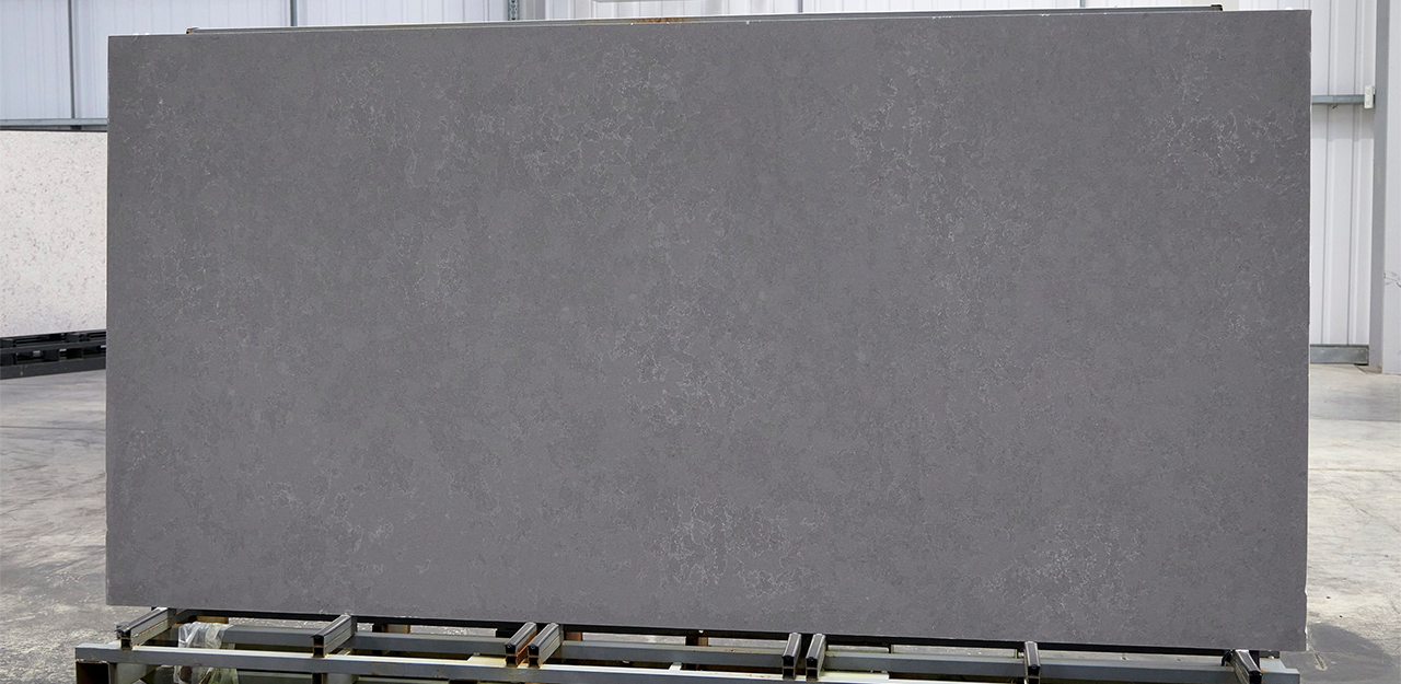 Full Slab view of Stella Gris Quartz with a dark and sultry colours by rich charcoal grey swirls that evoke the texture of natural slate.