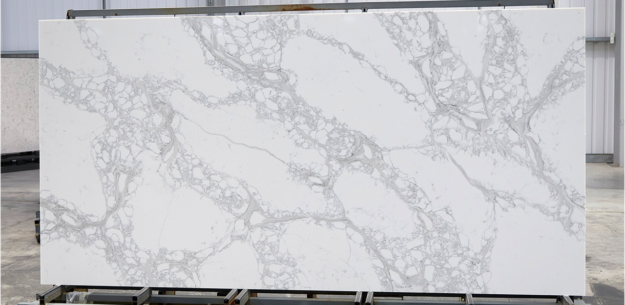 Full Slab view of Milano Quartz with a white surface and grey, brown veining.