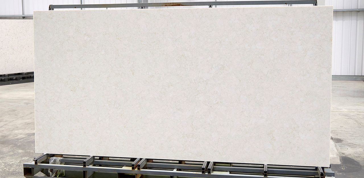 Full Slab view of Barletta Quartz with white surface, and beige and cream shades.
