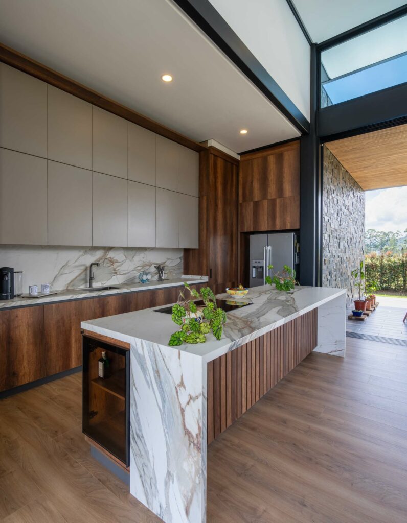 Featuring Macchia Vecchia, this dreamy kitchen showcases a stunning waterfall island and matching splashback.