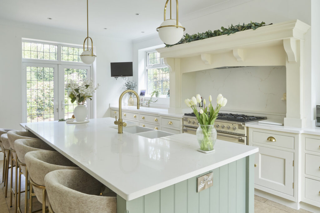another image of a dreamy kitchen which has Gold-Toned Surfaces. A warm kitchen with brushed brass tap and cabinet handle.