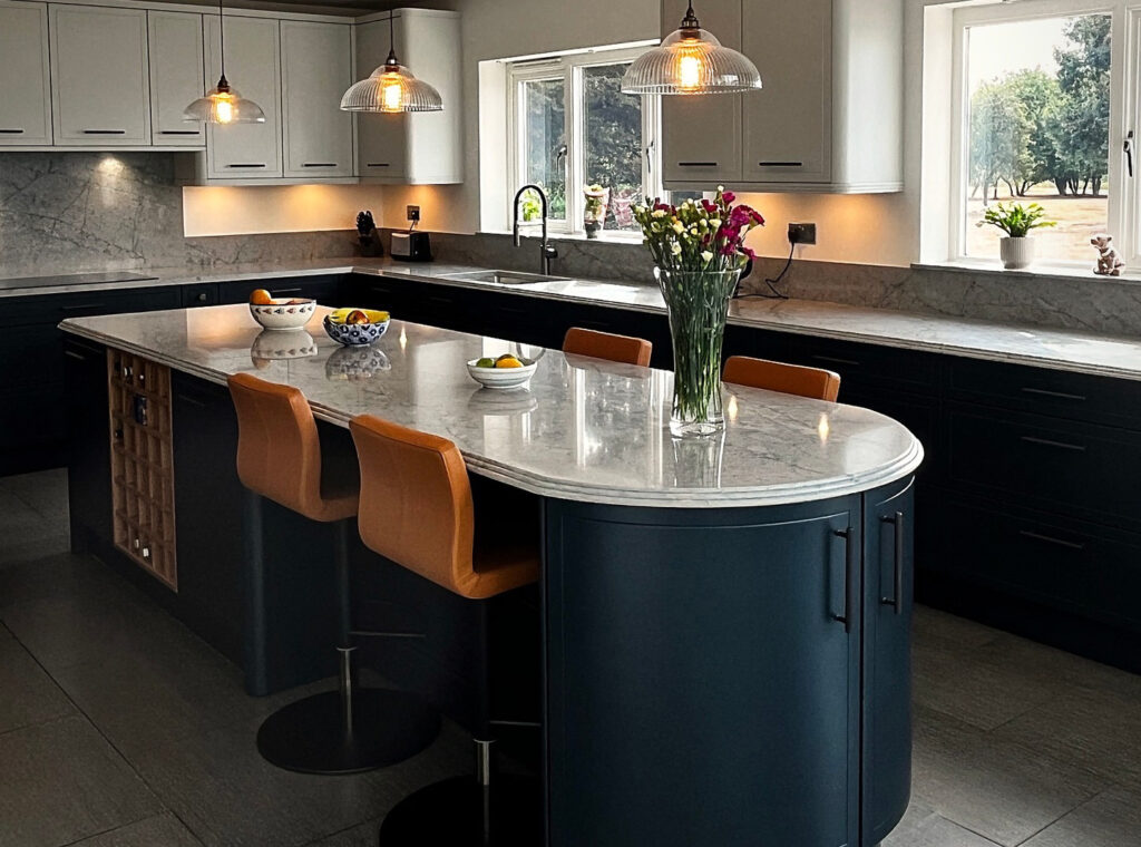Modern kitchen featuring a marble-look quartz island with curved edges.
