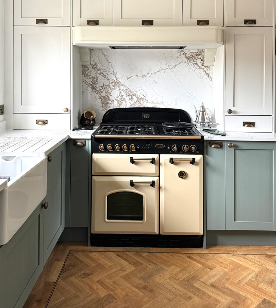 Traditional-style kitchen featuring a cream range cooker, marble-effect quartz splashback and worktops
