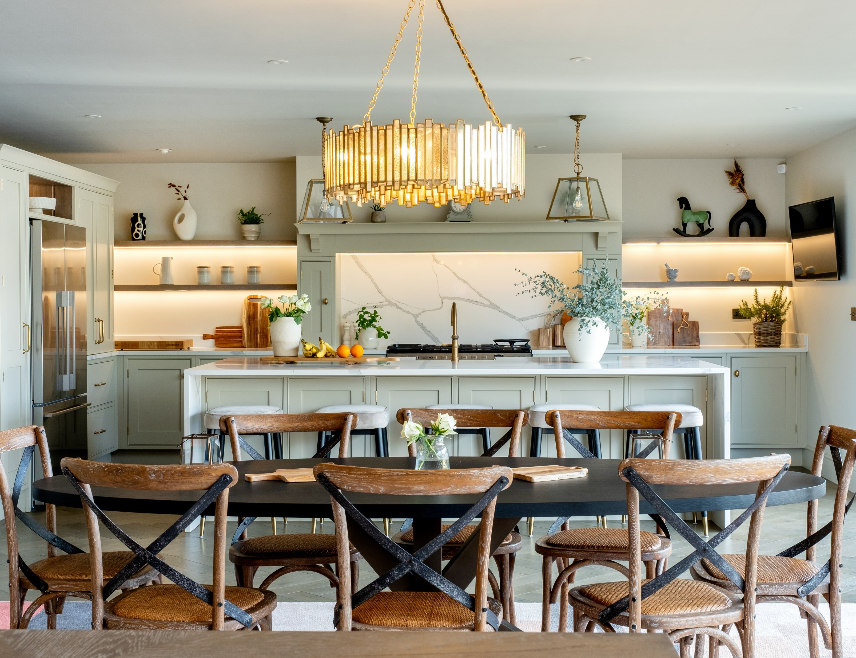Trendy open-plan kitchen and dining space featuring a large quartz-topped island.